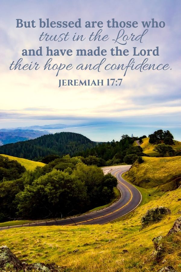 A picture of a road winding through hills by the ocean for this post of verses about trusting God. A bible verse written across the top reads, "But blessed are those who trust in the Lord and have made the Lord their hope and confidence." Jeremiah 17:7