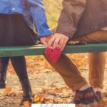 A Pinterest pin with a picture of a couple holding hands on a park bench. Designed for this post on how to love your husband unconditionally.