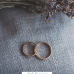 A Pinterest pin with a picture of two wedding rings beside blue flowers. Designed for this post about the importance of a love without conditions in marriage.