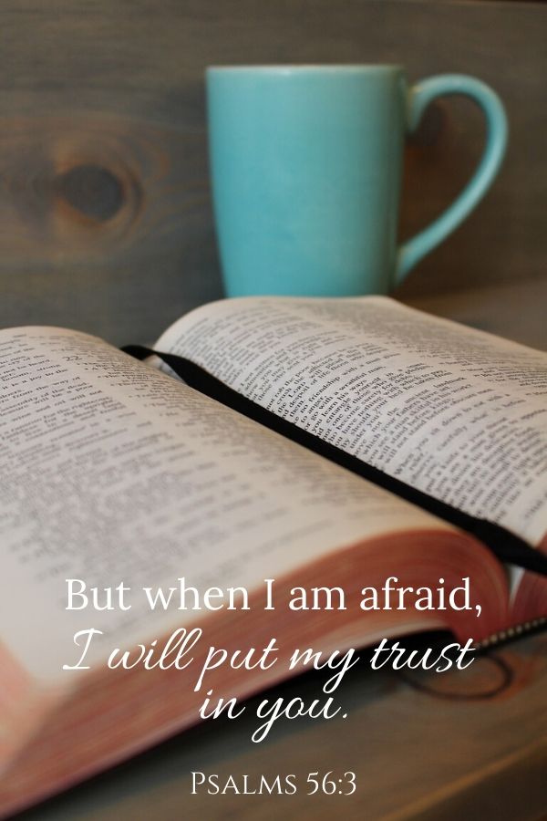 A picture of a Bible sitting by a coffee cup for this post about scriptures on fear. A bible verse written across the picture reads, "But when I am afraid, I will put my trust in you." Psalms 56:3