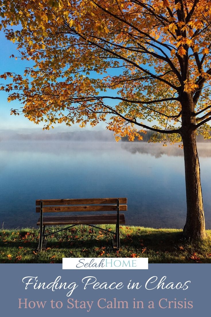 A Pinterest pin with a picture of an empty bench under an autumn tree by a lake. Designed for this post about finding peace in chaos.