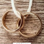 A Pinterest pin with a picture of a pair of wedding rings. Designed for this post of marriage resources.