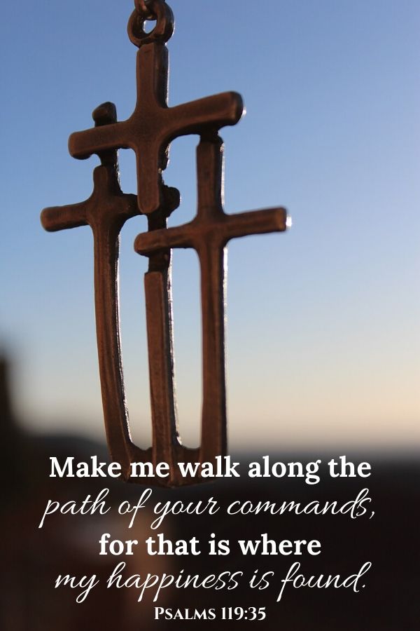 A picture of three crosses on a necklace for this post of verses about obedience to God. A verse written across the picture reads, "Make me walk along the path of your commands, for that is where my happiness is found." Psalms 119:35
