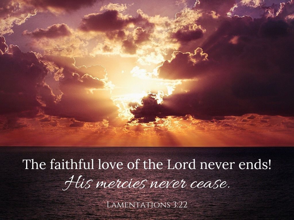 A picture of a sunset over the ocean for this post of verses about God's perfect love. A bible verse written across the bottom reads, "The faithful love of the Lord never ends! His mercies never cease." Lamentations 3:22