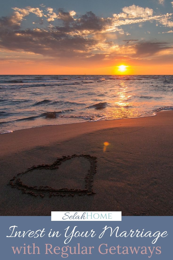 A Pinterest pin with a picture of a heart drawn in the sand at sunset. Designed for this post about investing in marriage by getting away together.
