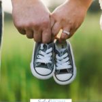 A Pinterest pin with a picture of a couple holding baby shoes. Designed for this post of parenting resources.