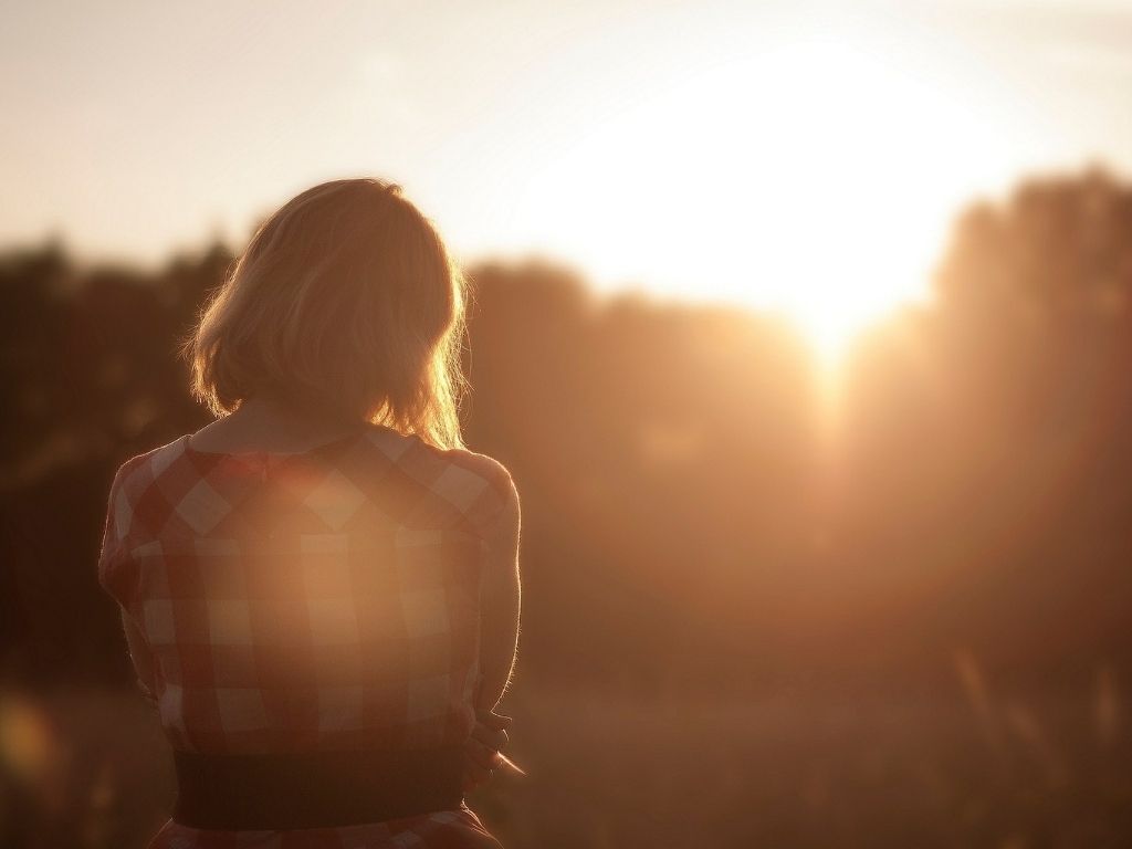A picture of a discouraged woman at sunset for this post about hope for the struggling mom.