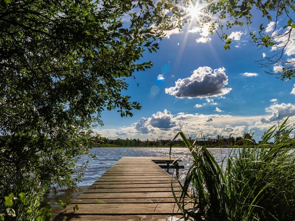 A picture of a dock stretching into a lake under a sunlit sky for this post about how nothing is impossible with God.