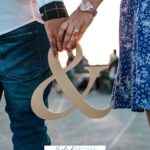 A Pinterest pin with a picture of a couple holding hands. Designed for this post about the importance of humor in marriage.