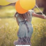 A Pinterest pin with a picture of a girl holding balloons and running through a field. Designed for this post of bible verses about choosing joy.
