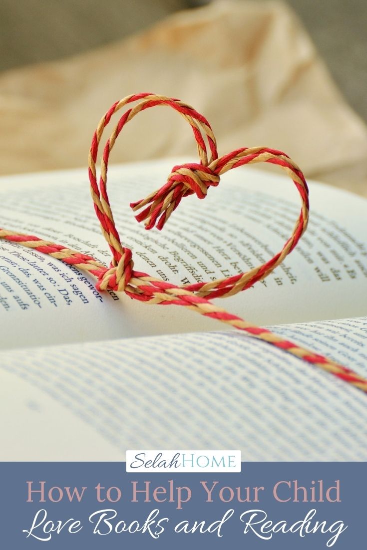 A Pinterest pin with a picture of an open book tied with a string in the shape of a heart. Designed for this post about raising a reader.