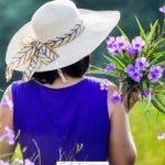 A Pinterest pin with a picture of a woman collecting flowers in an open field. Designed for this post about grief and hope after miscarriage.