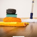 A Pinterest pin with a picture of cleaning supplies. Designed for this post on the benefits of doing household chores for kids.