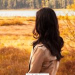 A Pinterest pin with a picture of a woman looking out over an open field. Designed for this post about waiting on God.