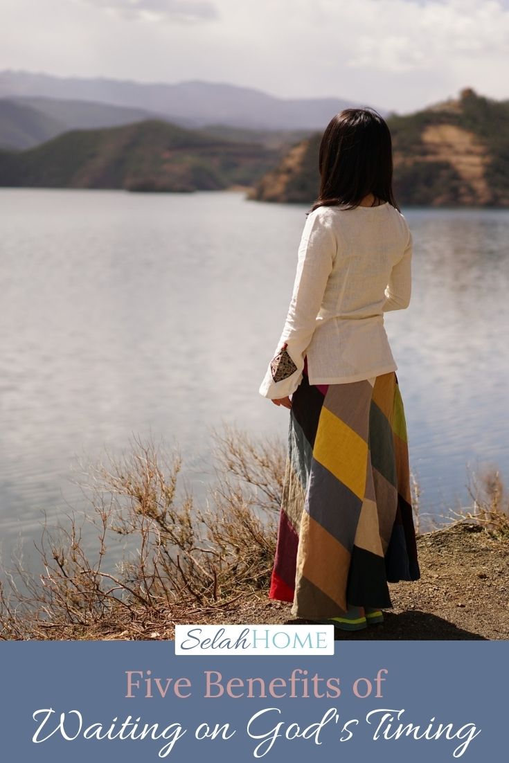 A Pinterest pin with a picture of a woman looking over a lake. Designed for this post about the benefits of waiting upon the Lord.