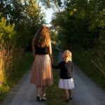 A picture of a mom walking with her daughter for this post about parenting choices.