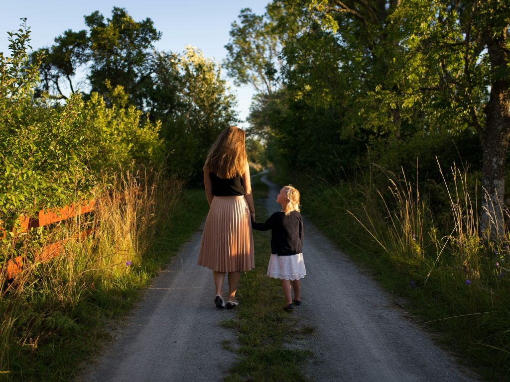 A picture of a mom walking with her daughter for this post about parenting choices.