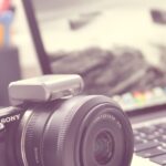 A picture of a camera and a computer for this post about how to declutter digital photos.