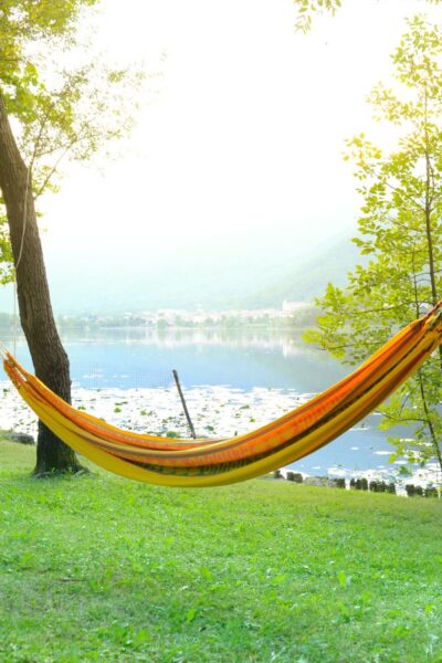 A picture of a hammock by the water for this post about how to have a tech free day.